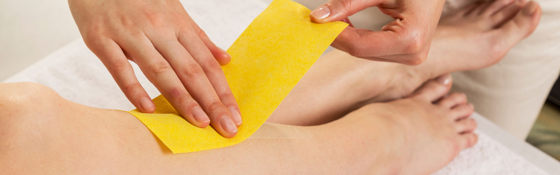 Close up Waxing in by a Beautician in a Spa Center